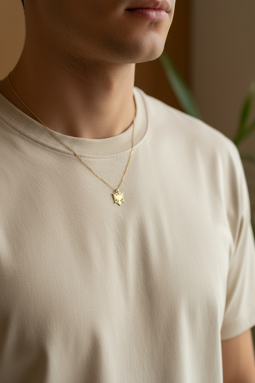 Mann trägt goldene albanische Adler-Kette